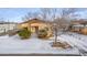 Aerial view of a house with snowy yard and surrounding area at 3780 Benton St, Wheat Ridge, CO 80212