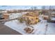 House with a brown roof and snowy yard, aerial view at 3780 Benton St, Wheat Ridge, CO 80212