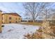 Large backyard with stone fireplace and partial house view at 3780 Benton St, Wheat Ridge, CO 80212