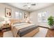 Main bedroom with hardwood floors and large windows at 3780 Benton St, Wheat Ridge, CO 80212