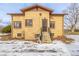 Brick ranch house with steps leading to the front door and a small yard at 3780 Benton St, Wheat Ridge, CO 80212