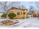 Ranch home with a snow-covered yard and attached garage at 3780 Benton St, Wheat Ridge, CO 80212