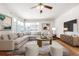 Living room featuring hardwood floors, sectional sofa, and large windows at 3780 Benton St, Wheat Ridge, CO 80212