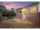 Charming backyard featuring a stone patio, garden bed, and convenient access to the house at 1025 E Iowa Ave, Denver, CO 80210