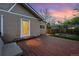 Backyard with wooden deck, door to home, privacy fence, and grass at dusk at 1025 E Iowa Ave, Denver, CO 80210