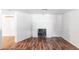 Basement room featuring a fireplace, hardwood floors, and freshly painted white walls at 1025 E Iowa Ave, Denver, CO 80210