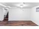 Spacious basement with wood-look flooring, white walls, and stairs to the upper level, perfect for customization at 1025 E Iowa Ave, Denver, CO 80210