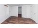 Basement rec room with modern wood-look floors and bright white walls, offering ample space for entertaining at 1025 E Iowa Ave, Denver, CO 80210