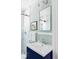 Charming bathroom with a vanity, a mirror, and a subway-tiled shower at 1025 E Iowa Ave, Denver, CO 80210