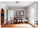 Bright dining room featuring hardwood floors, a round table, and contemporary chairs for a stylish dining experience at 1025 E Iowa Ave, Denver, CO 80210