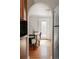 Charming dining room showcases hardwood floors and a decorative archway leading to the kitchen, with a decorative glass door at 1025 E Iowa Ave, Denver, CO 80210
