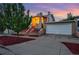 Charming home with landscaped front yard, garage, and a welcoming entrance, set against a beautiful evening sky at 1025 E Iowa Ave, Denver, CO 80210
