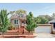 Charming home with a well-maintained front yard, landscaped garden, and inviting entryway at 1025 E Iowa Ave, Denver, CO 80210