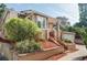 Charming home with a well-manicured front yard, brick facade, and inviting steps to the front door at 1025 E Iowa Ave, Denver, CO 80210