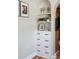 Elegant hallway cabinet with shelving, artwork, and a drawer, adding a touch of sophistication to the interior decor at 1025 E Iowa Ave, Denver, CO 80210