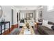 Inviting living room featuring hardwood floors, neutral walls, and a seamless transition to the dining area for easy entertaining at 1025 E Iowa Ave, Denver, CO 80210