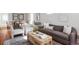 Bright living room featuring stylish furniture, a decorative rug, and ample natural light at 1025 E Iowa Ave, Denver, CO 80210