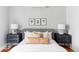 Serene main bedroom featuring a comfortable bed, stylish lamps, and minimalist decor for a peaceful retreat at 1025 E Iowa Ave, Denver, CO 80210