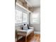 Cozy sitting nook featuring a cushioned bench, bright windows, and hardwood floors for a relaxing space at 1025 E Iowa Ave, Denver, CO 80210