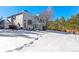 Large backyard with snow covered lawn and home view at 317 Ingleton Ct, Castle Pines, CO 80108