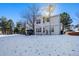 Two story house with a large backyard covered in snow at 317 Ingleton Ct, Castle Pines, CO 80108