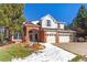 Two-story house with a brick facade and attached two car garage at 317 Ingleton Ct, Castle Pines, CO 80108