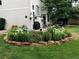 Landscaped garden with a variety of flowers and plants, surrounded by stone edging at 317 Ingleton Ct, Castle Pines, CO 80108