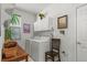 Laundry room with washer, dryer, and built-in shelving at 317 Ingleton Ct, Castle Pines, CO 80108