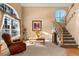 Bright living room with hardwood floors and large windows at 317 Ingleton Ct, Castle Pines, CO 80108