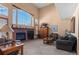 Spacious living room featuring a fireplace and large windows at 317 Ingleton Ct, Castle Pines, CO 80108