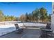 Relaxing patio area with seating for enjoying the snowy landscape at 317 Ingleton Ct, Castle Pines, CO 80108