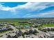 An aerial view captures a neighborhood with a pool, green spaces, and well-maintained homes at 14116 Double Dutch Cir, Parker, CO 80134