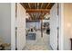 Unfinished basement with exposed beams and plenty of storage space behind an open doorway at 14116 Double Dutch Cir, Parker, CO 80134