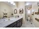 Bathroom with double vanity, marble countertops, ornate mirrors and fixtures at 14116 Double Dutch Cir, Parker, CO 80134