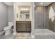 Modern bathroom featuring granite vanity, walk-in shower with grey tile, and neutral tones at 14116 Double Dutch Cir, Parker, CO 80134