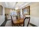 Formal dining room with chandelier, decorative window treatments, and wainscoting detail at 14116 Double Dutch Cir, Parker, CO 80134