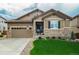 Charming single-Gathering home with a well-manicured lawn, stone accents, and a two-car attached garage at 14116 Double Dutch Cir, Parker, CO 80134