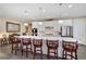 Elegant kitchen island with white cabinetry, pendant lighting, and seating for four at 14116 Double Dutch Cir, Parker, CO 80134