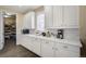Bright kitchen with white cabinets, marble countertops, and a view into a pantry with lots of storage space at 14116 Double Dutch Cir, Parker, CO 80134