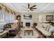 A stylish living room with coffered ceilings, a fireplace, plush seating, and elegant decor at 14116 Double Dutch Cir, Parker, CO 80134