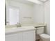 Clean, all-white bathroom featuring a large mirror, a vanity with sink, and a toilet at 9057 Bermuda Run Cir, Highlands Ranch, CO 80130