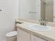 Bathroom featuring a sink, toilet, large mirror, and shower with tile surround at 9057 Bermuda Run Cir, Highlands Ranch, CO 80130