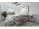 Bright bedroom with a large window, ceiling fan, and a soothing color palette at 9057 Bermuda Run Cir, Highlands Ranch, CO 80130