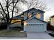 Charming two-story home with an attached two-car garage and mature trees in front yard at 9057 Bermuda Run Cir, Highlands Ranch, CO 80130