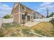 A quaint backyard with a patio, partial lawn, and a basketball hoop for outdoor enjoyment at 5550 Malta St, Denver, CO 80249