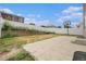 Fenced backyard featuring a concrete patio, a basketball hoop, and a small garden at 5550 Malta St, Denver, CO 80249