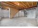 Unfinished basement with exposed beams, concrete flooring, and utilities at 5550 Malta St, Denver, CO 80249