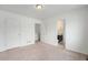 Bedroom features neutral walls, carpet, and access to the bathroom and closet at 5550 Malta St, Denver, CO 80249