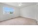 Bedroom with carpet, a ceiling fan, and a large window overlooking the neighborhood at 5550 Malta St, Denver, CO 80249