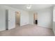 Bedroom with carpet, ceiling fan, walk-in closet, and an ensuite bathroom at 5550 Malta St, Denver, CO 80249